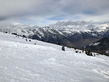 Scenic view of snow covered mountains against sky