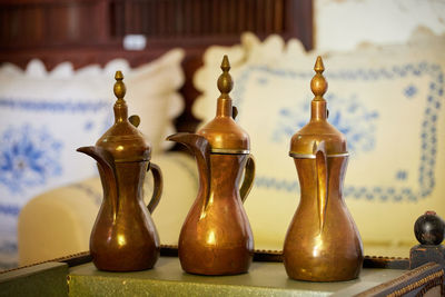 Close-up of candles on table against wall