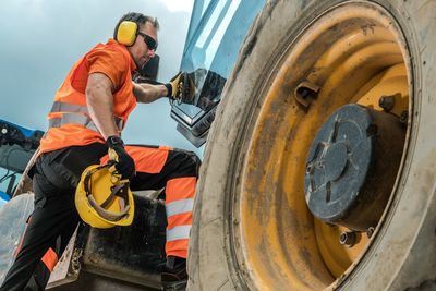 Man standing on construction vehicle