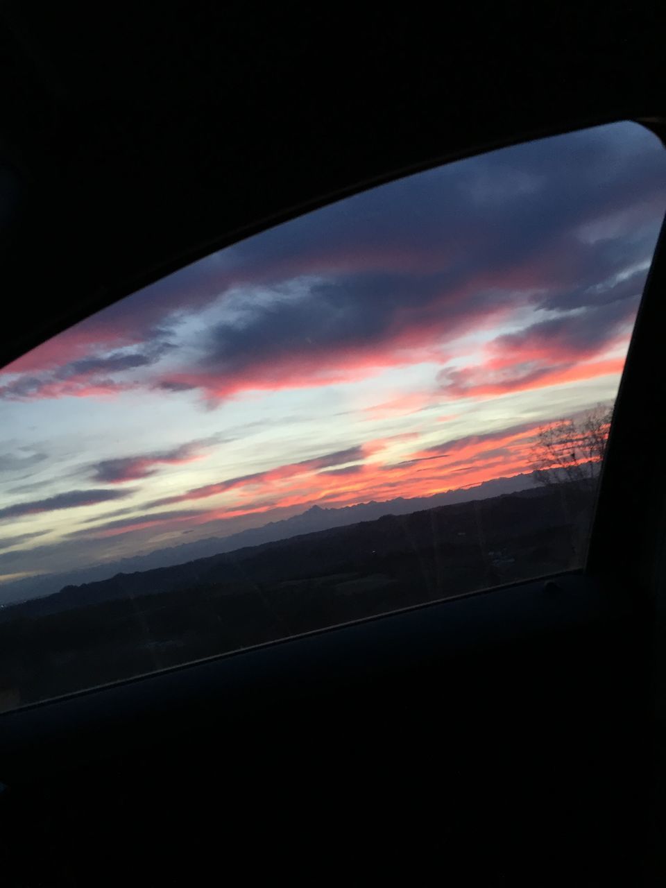 LOW ANGLE VIEW OF DRAMATIC SKY OVER SILHOUETTE CAR WINDOW