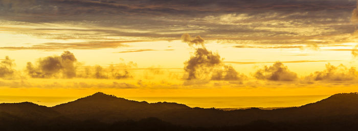 Scenic view of silhouette mountains against sky at sunset