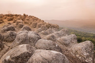 Rock formations on landscape against sky