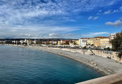 View of town by sea against sky