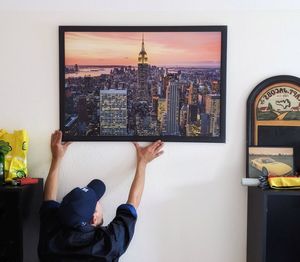 Rear view of man standing against wall