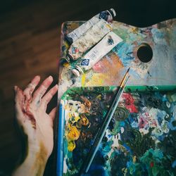 High angle view of hand against graffiti