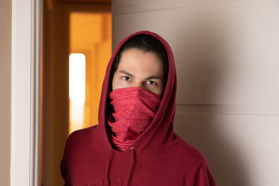 Portrait of beautiful young woman covering face