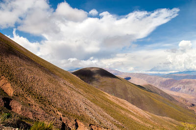 Scenic view of mountains against cloudy sky