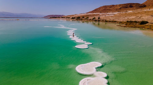 Loving couple is resting on the dead sea. salt coastline, the sea in israel dies out and dries up