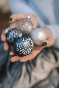 Midsection of woman holding christmas ornaments