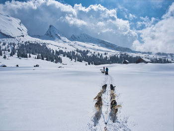 Scenic view of snow covered mountains against sky