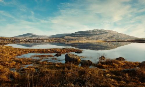 Morning landscape scenery, mountains reflected in lake at burren, county clare, ireland