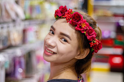 Close-up side view portrait of smiling young woman wearing tiara