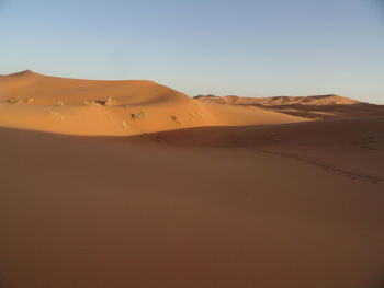 Scenic view of desert against clear sky