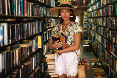 Portrait of woman standing in library