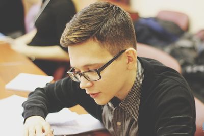 Close-up of young man studying in classroom