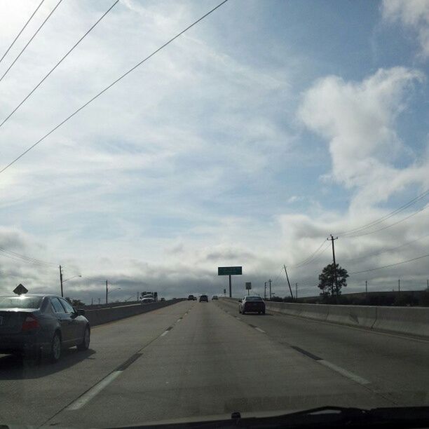 transportation, sky, mode of transport, road, cloud - sky, the way forward, land vehicle, car, road marking, cloudy, street, diminishing perspective, cloud, vanishing point, day, travel, built structure, outdoors, on the move, no people