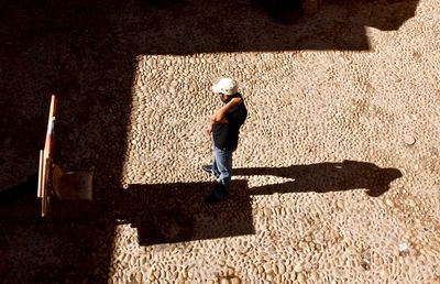 High angle view of man skateboarding on sunny day