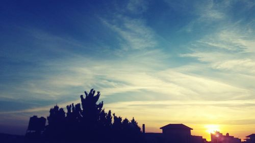 Low angle view of silhouette city against sky