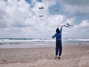 Rear view of boy on beach