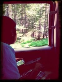 Woman looking through train window