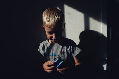 Close-up of boy playing with toy car