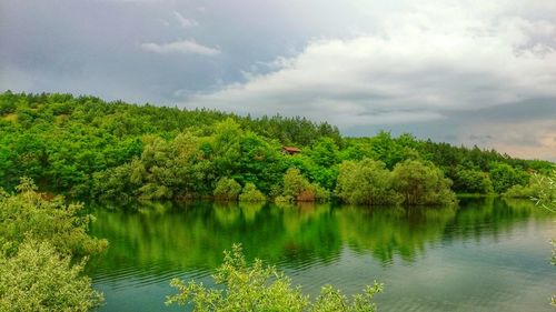 Scenic view of lake against cloudy sky