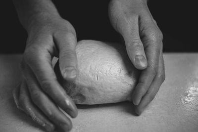 Male hands rolling out pizza dough black and white