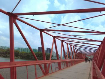 Footbridge against sky in city