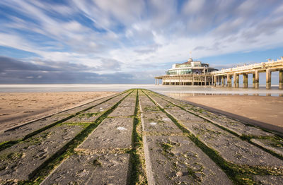 Surface level view of beach against sky in city