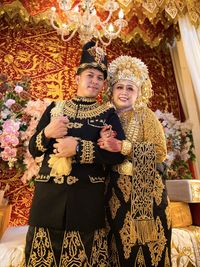A photo of aceh couple in their traditional wedding dress in indonesia