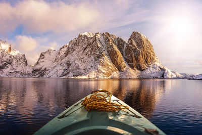 Scenic view of snowcapped mountains by lake against sky