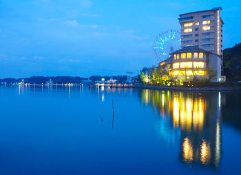 Reflection of illuminated buildings in lake at night