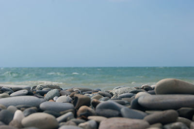 Stones on beach against sky