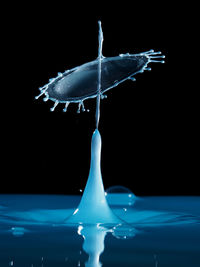 Close-up of water splashing over black background