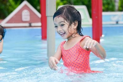 Close-up of cute playful girl at water park