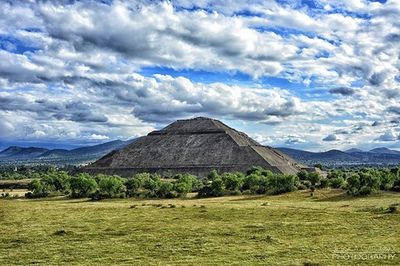 Scenic view of mountains against cloudy sky