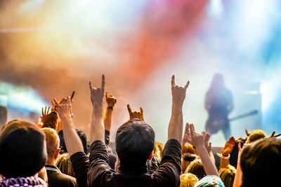 Crowd at music concert against sky