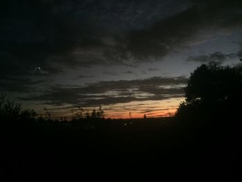 Scenic view of silhouette landscape against sky at sunset