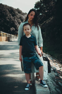 Portrait of mother and son on footpath