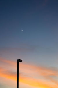Low angle view of silhouette street light against sky during sunset