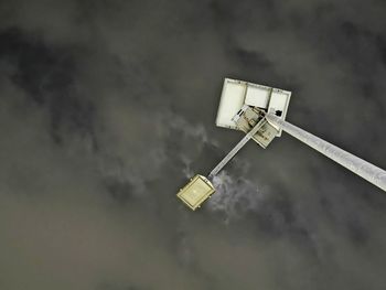 Low angle view of telephone pole against sky