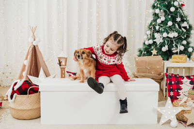 Portrait of young woman with dogs in bathtub at home