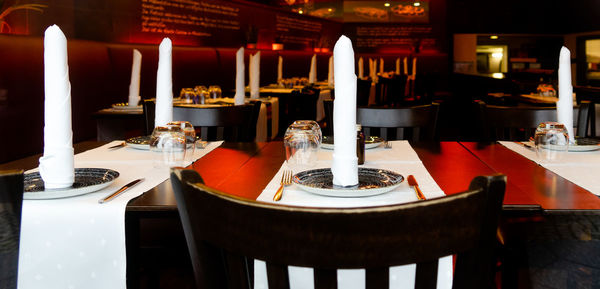 Empty chairs and tables in restaurant