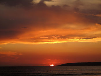 Scenic view of sea against orange sky