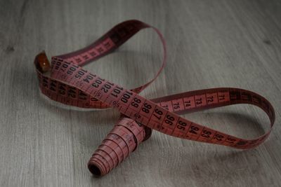 High angle view of tape measure on wooden table