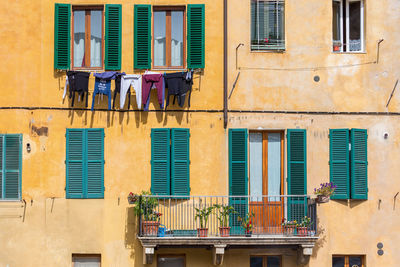 Clothes hanging to dry at the windows