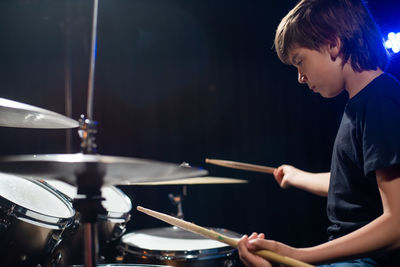 Man playing drum at home