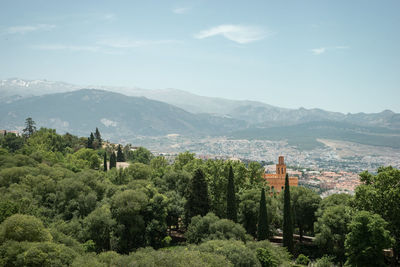 Scenic view of trees and mountains against sky