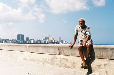 Full length of man on wall against sky