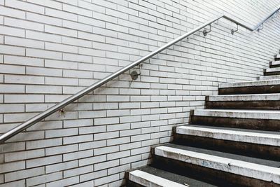 Railing on brick wall by steps